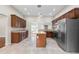 Modern kitchen featuring stainless steel appliances, tile flooring, a center island, and ample counter space at 102 Deen Blvd, Auburndale, FL 33823