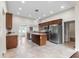 Spacious kitchen with stainless steel appliances, center island, tile flooring, and ample cabinet space at 102 Deen Blvd, Auburndale, FL 33823