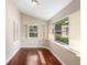 Cozy sunroom with hardwood floors and lots of natural light from the large windows at 102 Deen Blvd, Auburndale, FL 33823