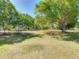 A well-manicured lawn and mature trees create a peaceful backyard setting at 1024 Campbell Ave, Lake Wales, FL 33853