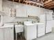 Basement laundry area with washer, dryer, utility sink, and unfinished ceiling at 1024 Campbell Ave, Lake Wales, FL 33853