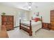 Cozy bedroom with wood furniture, ceiling fan and natural light at 1024 Campbell Ave, Lake Wales, FL 33853