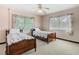 Bedroom with two twin beds, hardwood floors, a window and floral print curtains at 1024 Campbell Ave, Lake Wales, FL 33853