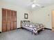 Cozy bedroom featuring patterned carpet, a comfortable bed with a quilt, and a ceiling fan at 1024 Campbell Ave, Lake Wales, FL 33853