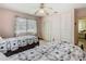 Comfortable bedroom with two twin beds, a window with blinds, and ample closet space at 1024 Campbell Ave, Lake Wales, FL 33853