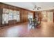 Dining room with wood paneling, brick accents and decorative tile floors at 1024 Campbell Ave, Lake Wales, FL 33853