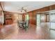 Open dining area with wood paneling, brick accent wall, and decorative tile floors at 1024 Campbell Ave, Lake Wales, FL 33853