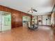 Dining area with wood paneled walls, decorative tile floors, and built-in shelves at 1024 Campbell Ave, Lake Wales, FL 33853