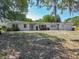 Charming single-story home featuring a clean white exterior, mature trees, and a well-maintained front lawn at 1024 Campbell Ave, Lake Wales, FL 33853