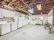 Garage featuring exposed beams, laundry area, storage shelving, and garage door at 1024 Campbell Ave, Lake Wales, FL 33853