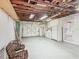 Spacious garage with exposed beams, laundry area, storage and garage door at 1024 Campbell Ave, Lake Wales, FL 33853