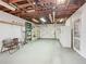 Spacious garage featuring exposed beams, shelving and garage door at 1024 Campbell Ave, Lake Wales, FL 33853