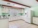 Bright kitchen features white cabinets, tile floors, and modern appliances at 1024 Campbell Ave, Lake Wales, FL 33853