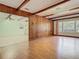 Inviting living room with wooden paneling, exposed beams, large windows, and an open layout at 1024 Campbell Ave, Lake Wales, FL 33853
