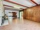 Bright living room featuring a stone fireplace, hardwood floors, exposed beams, and multiple access points at 1024 Campbell Ave, Lake Wales, FL 33853