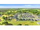 Aerial view of the community showing many homes, green spaces, and a pond at 1045 Montgomery Ln, Polk City, FL 33868
