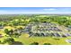 Aerial view of the community showing many homes, green spaces, and a pond at 1045 Montgomery Ln, Polk City, FL 33868
