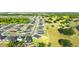 Aerial view showing many homes in the community, a pond, and green spaces at 1045 Montgomery Ln, Polk City, FL 33868