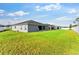 Expansive backyard showcasing a well-maintained lawn, privacy fence and home's exterior at 1045 Montgomery Ln, Polk City, FL 33868