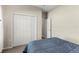 Bedroom with neutral walls, a bed, large closet with folding doors and another door at 1045 Montgomery Ln, Polk City, FL 33868