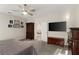 Bedroom features a ceiling fan, TV, and furniture providing ample storage space at 1045 Montgomery Ln, Polk City, FL 33868