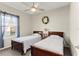 Bedroom offers two twin beds, ceiling fan, and a window with curtains at 1045 Montgomery Ln, Polk City, FL 33868