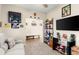 Comfortable bedroom featuring neutral paint, ceiling fan, carpeting, natural light and sport-themed décor at 1045 Montgomery Ln, Polk City, FL 33868