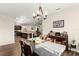 Open dining area with chandelier, table, and views of the kitchen and living room, perfect for entertaining at 1045 Montgomery Ln, Polk City, FL 33868