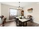 Cozy dining room with a chandelier, a rustic table with seating for six, and wood-look flooring at 1045 Montgomery Ln, Polk City, FL 33868