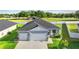 Charming single-story home with a three-car garage, landscaped yard, and beautiful curb appeal at 1045 Montgomery Ln, Polk City, FL 33868