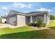 This house has a three-car garage, pristine landscaping with decorative accents, and a well-maintained lawn at 1045 Montgomery Ln, Polk City, FL 33868
