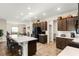 Bright kitchen featuring a large island with seating, stainless steel appliances, and dark wood cabinets at 1045 Montgomery Ln, Polk City, FL 33868