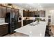 Modern kitchen with stainless steel appliances, quartz countertops, and dark wood cabinetry at 1045 Montgomery Ln, Polk City, FL 33868