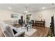 Cozy living room featuring wood floors, a ceiling fan, and sliding glass doors to the outside at 1045 Montgomery Ln, Polk City, FL 33868