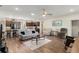 Spacious living room with wood floors, comfortable seating, and an open layout to the kitchen at 1045 Montgomery Ln, Polk City, FL 33868
