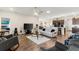 Open-concept living room with a view into the kitchen, featuring hardwood floors and comfortable seating at 1045 Montgomery Ln, Polk City, FL 33868