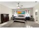 Spacious main bedroom featuring neutral paint, a ceiling fan, carpeting, and an ensuite bathroom at 1045 Montgomery Ln, Polk City, FL 33868