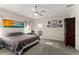Spacious main bedroom featuring neutral paint, a ceiling fan, carpeting, and an ensuite bathroom at 1045 Montgomery Ln, Polk City, FL 33868