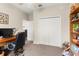 Home office features carpeting, a ceiling fan, a closet, a desk, and a window for natural light at 1045 Montgomery Ln, Polk City, FL 33868