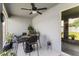 Relaxing screened patio with ceiling fan, table and chairs, and lush green plants at 1045 Montgomery Ln, Polk City, FL 33868