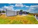 Green backyard featuring a shed and screened-in patio with a view of the lake at 108 Lake Howard Dr Nw, Winter Haven, FL 33880