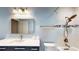 Bathroom featuring a large mirror, a vanity with a solid countertop, and shower with dual showerheads at 108 Lake Howard Dr Nw, Winter Haven, FL 33880