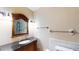 Bathroom featuring vanity with granite countertop and decorative mirror at 108 Lake Howard Dr Nw, Winter Haven, FL 33880