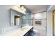 Bathroom featuring a vanity with a solid countertop, a large mirror, and a shower at 108 Lake Howard Dr Nw, Winter Haven, FL 33880