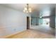 Open dining space with a chandelier and natural light, flowing into a carpeted living area at 108 Lake Howard Dr Nw, Winter Haven, FL 33880