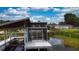 A waterfront property featuring a dock with an enclosed seating area at 108 Lake Howard Dr Nw, Winter Haven, FL 33880