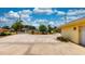 Long driveway featuring a circular turnaround and landscaping in front of a yellow brick home at 108 Lake Howard Dr Nw, Winter Haven, FL 33880