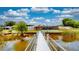 Wide angle view of home and yard with dock access showing outdoor living at its finest at 108 Lake Howard Dr Nw, Winter Haven, FL 33880