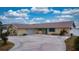 Charming single-story home featuring a two-car garage and a circular driveway at 108 Lake Howard Dr Nw, Winter Haven, FL 33880