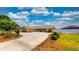 Charming yellow home with blue shutters and a spacious driveway with well-maintained landscaping at 108 Lake Howard Dr Nw, Winter Haven, FL 33880